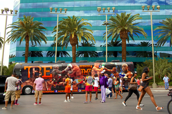 Fans take pictures with Floyd Mayweather's bus in front of the MGM Grand in Las Vegas on Saturday, May 2, 2015.